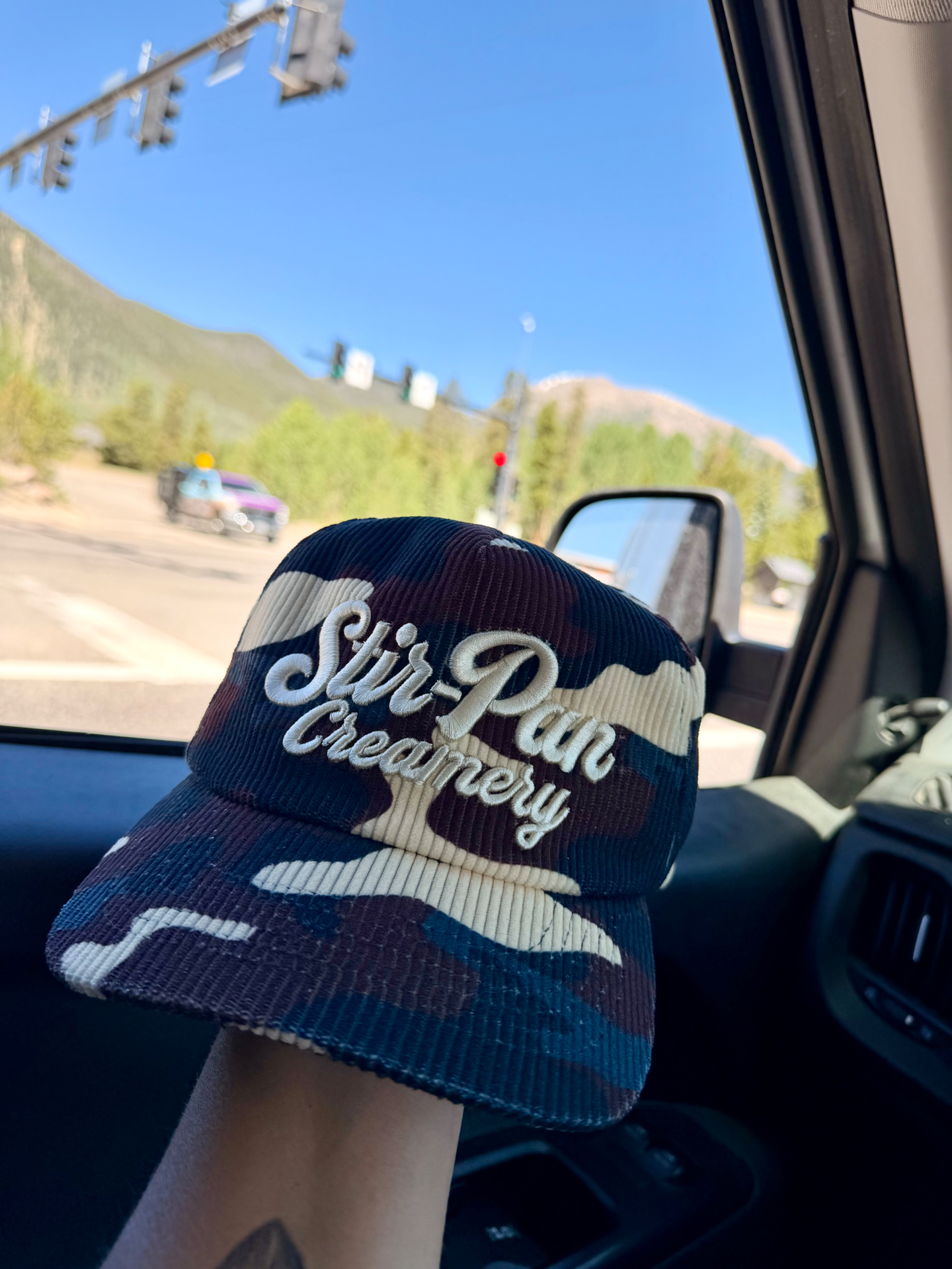 Avalanche Camo corduroy cap photographed in the mountains